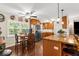 This eat-in kitchen features wood floors, wooden cabinets, stainless steel appliances, and breakfast table near the window at 7339 Thomas St, Englewood, FL 34224