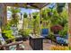 Charming patio with fire table, fan, and tropical foliage for relaxing outdoors at 7339 Thomas St, Englewood, FL 34224
