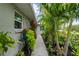 Cozy side yard with lush tropical landscaping along walkway at 7339 Thomas St, Englewood, FL 34224