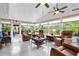 Bright sunroom with tile floors, many windows, and comfortable seating at 7339 Thomas St, Englewood, FL 34224