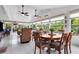 Bright sunroom with tile floors, ceiling fans, and plenty of seating at 7339 Thomas St, Englewood, FL 34224