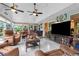 Large sunroom with tile floors, television, and comfortable seating for many at 7339 Thomas St, Englewood, FL 34224
