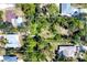 Aerial property lines show location among mature trees and neighboring houses at 745 Sesame St, Englewood, FL 34223