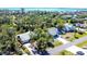 Aerial view of two homes with well-maintained landscaping and long driveways surrounded by lush trees at 745 Sesame St, Englewood, FL 34223