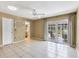 Spacious bedroom with tile flooring, ceiling fan, and french doors leading to an outdoor space at 745 Sesame St, Englewood, FL 34223