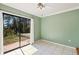 Light-filled bedroom with large sliding glass door and neutral wall color at 745 Sesame St, Englewood, FL 34223