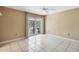 Large bedroom with tile floors, ceiling fan, and sliding glass doors at 745 Sesame St, Englewood, FL 34223