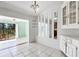 View of a dining area with mirrors, built-in corner cabinet, and sliding glass doors to the outside at 745 Sesame St, Englewood, FL 34223