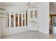 Dining area featuring mirrors, corner cabinet, and tile flooring at 745 Sesame St, Englewood, FL 34223