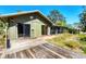 Charming home featuring a wooden deck and screened-in porch, perfect for enjoying the outdoors at 745 Sesame St, Englewood, FL 34223