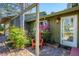 Inviting outdoor area with brick flooring, blooming flowers, and a comfortable chair near the home's entrance at 745 Sesame St, Englewood, FL 34223