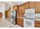 Bright kitchen featuring stainless steel refrigerator, white appliances, and ample cabinet space at 745 Sesame St, Englewood, FL 34223