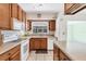 Charming kitchen with window over the sink and wood cabinets at 745 Sesame St, Englewood, FL 34223