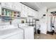 Functional laundry room featuring ample storage cabinets and a utility sink for added convenience at 745 Sesame St, Englewood, FL 34223