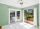 Bright living area with ceiling fan and sliding glass doors leading to the patio at 745 Sesame St, Englewood, FL 34223