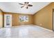 Inviting living room with tile floors, large window, and a door leading to the outside at 745 Sesame St, Englewood, FL 34223