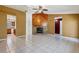 Spacious living room featuring tile floors, a cozy fireplace, and easy access to the kitchen and hallway at 745 Sesame St, Englewood, FL 34223