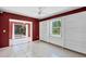 Spacious living room featuring a sliding glass door, tile flooring, and built-in shelving, perfect for comfort at 745 Sesame St, Englewood, FL 34223