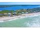 Picturesque aerial view of beachfront homes with clear turquoise waters, idyllic coastal living at 7820 Manasota Key Rd, Englewood, FL 34223