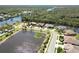 Community aerial showcasing pond, waterfront homes, and manicured streets at 8784 Mystic Cir, North Port, FL 34287