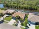 An aerial view showing a home's landscaping, boat dock and waterway access at 8784 Mystic Cir, North Port, FL 34287