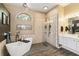 Bathroom showcasing a freestanding tub, a glass-enclosed shower, and modern fixtures at 8784 Mystic Cir, North Port, FL 34287