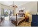 Bright bedroom overlooking the pool with outdoor access and features a tropically styled ceiling fan at 8784 Mystic Cir, North Port, FL 34287
