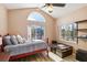 Cozy bedroom featuring a ceiling fan, a vaulted ceiling, and ample natural light from the large window at 8784 Mystic Cir, North Port, FL 34287