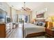 Bright bedroom with a ceiling fan, outdoor view, and tropical decor that provides a tranquil retreat at 8784 Mystic Cir, North Port, FL 34287
