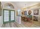 Bright dining room featuring a glass table, wicker chairs, and charming decor at 8784 Mystic Cir, North Port, FL 34287