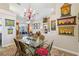 Bright dining room with glass table, seating for six, and colorful decor at 8784 Mystic Cir, North Port, FL 34287
