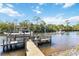 Waterfront living with a private dock, boat lift, and ample space for enjoying scenic water views at 8784 Mystic Cir, North Port, FL 34287