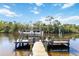 Private dock with boat lift offering easy access to waterways for boating and fishing at 8784 Mystic Cir, North Port, FL 34287