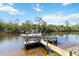 This house features a private dock and boat lift, perfect for accessing the waterway at 8784 Mystic Cir, North Port, FL 34287