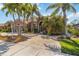 Inviting single-story home with mature landscaping, and an arched entryway door at 8784 Mystic Cir, North Port, FL 34287