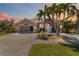 Inviting single-story home with lush landscaping and swaying palm trees for tropical curb appeal at 8784 Mystic Cir, North Port, FL 34287