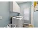 Laundry room features modern washer, dryer, and cabinetry at 8784 Mystic Cir, North Port, FL 34287