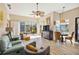 Bright living room with tiled floors, comfortable seating, and large windows at 8784 Mystic Cir, North Port, FL 34287