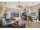 Inviting living room featuring comfortable seating, neutral tones, and backyard views at 8784 Mystic Cir, North Port, FL 34287