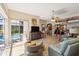 Open-concept living area with pool view, bar seating, and comfortable furnishings at 8784 Mystic Cir, North Port, FL 34287
