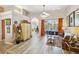 Spacious living room with neutral tones, ceiling fan, and sliding glass doors at 8784 Mystic Cir, North Port, FL 34287