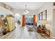 Open-concept living room with tile floors, ceiling fan, and natural light at 8784 Mystic Cir, North Port, FL 34287