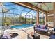 This covered patio offers scenic views of the water and the refreshing pool area at 8784 Mystic Cir, North Port, FL 34287
