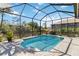 The inviting screened pool provides a refreshing escape and relaxing views of the lush surroundings at 8784 Mystic Cir, North Port, FL 34287