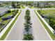 Landscaped entrance to the community with sidewalks, palm trees, and well-maintained lawns at 8784 Mystic Cir, North Port, FL 34287