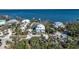 Breathtaking aerial shot capturing waterfront properties nestled amidst lush foliage, boasting serene water views at 9 Peekins Cove Dr, Boca Grande, FL 33921