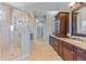 Spacious bathroom featuring a glass enclosed shower, double vanity, and neutral tile at 9 Peekins Cove Dr, Boca Grande, FL 33921