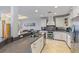 Elegant kitchen featuring granite countertops, white cabinetry, stainless steel appliances, and a seamless flow to the dining area at 9 Peekins Cove Dr, Boca Grande, FL 33921