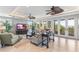 Spacious living room featuring tile floors, ceiling fans, ample seating, and large windows offering scenic views at 9 Peekins Cove Dr, Boca Grande, FL 33921