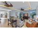 Well-appointed living room featuring stylish furniture, ceiling fans, recessed lighting, and scenic outdoor views at 9 Peekins Cove Dr, Boca Grande, FL 33921